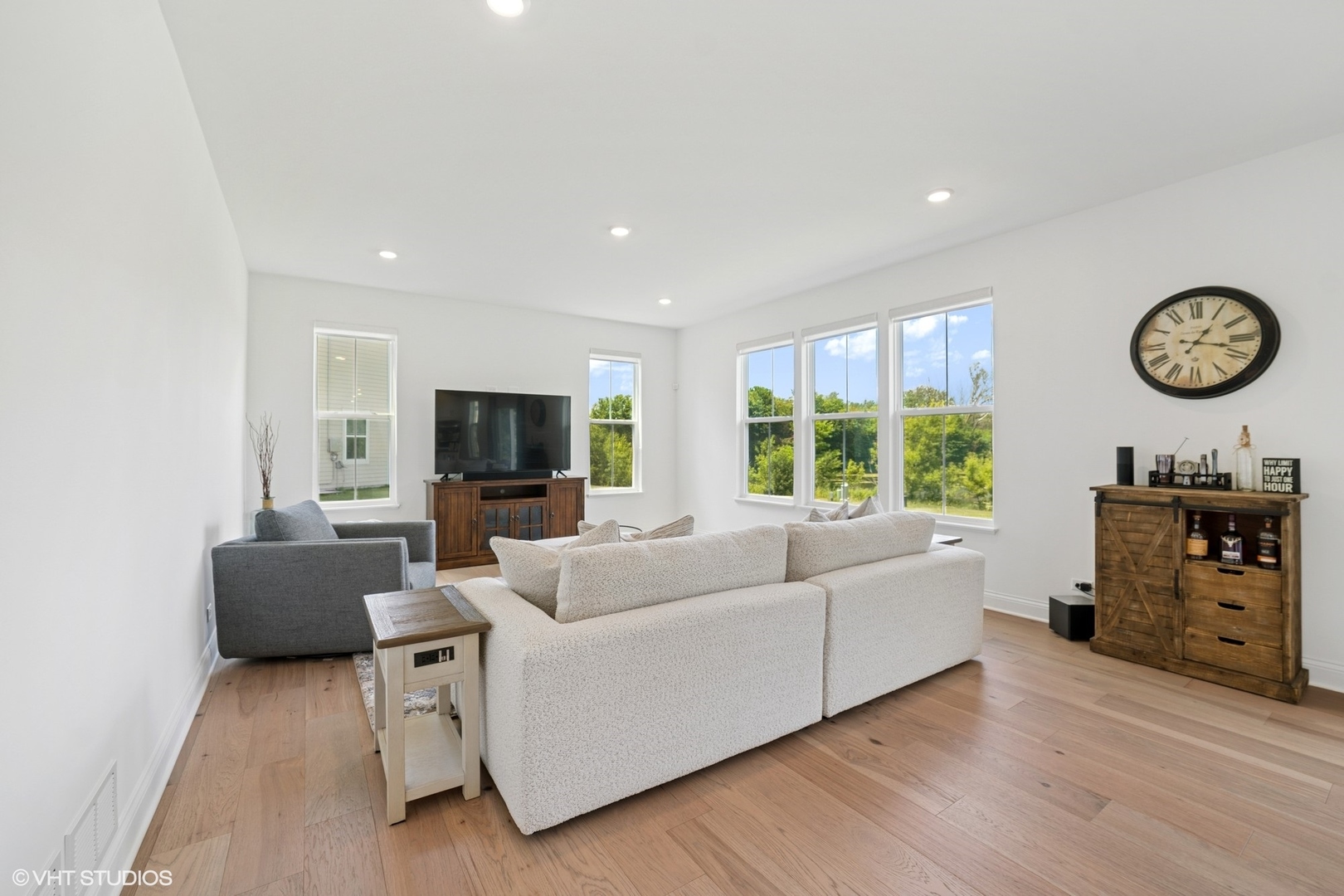 117 Hedgerow Drive Elgin, IL 60124 - Photo 8 of 26 a living room with furniture a fireplace and a flat screen tv