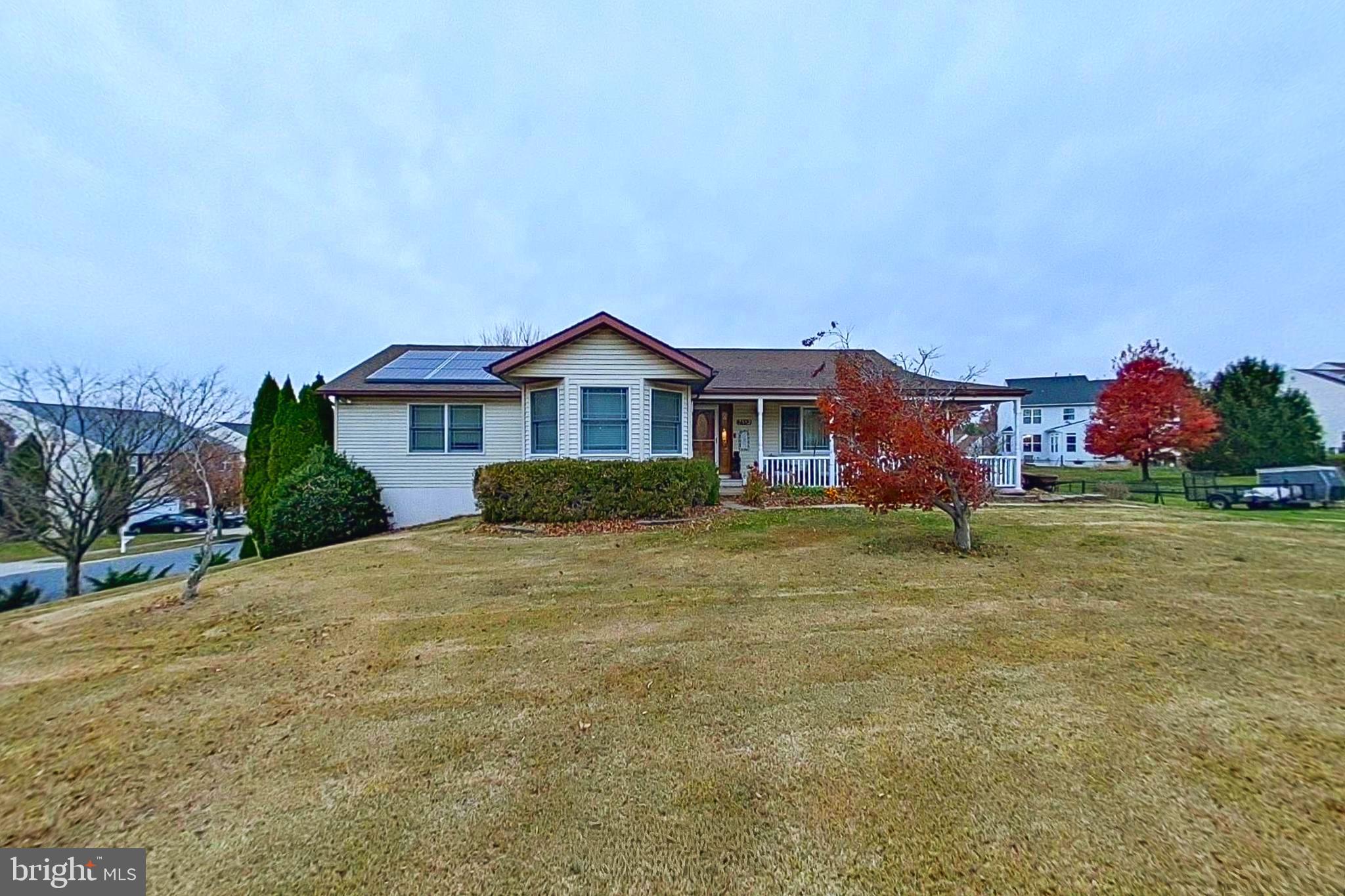 a front view of a house with a garden and yard