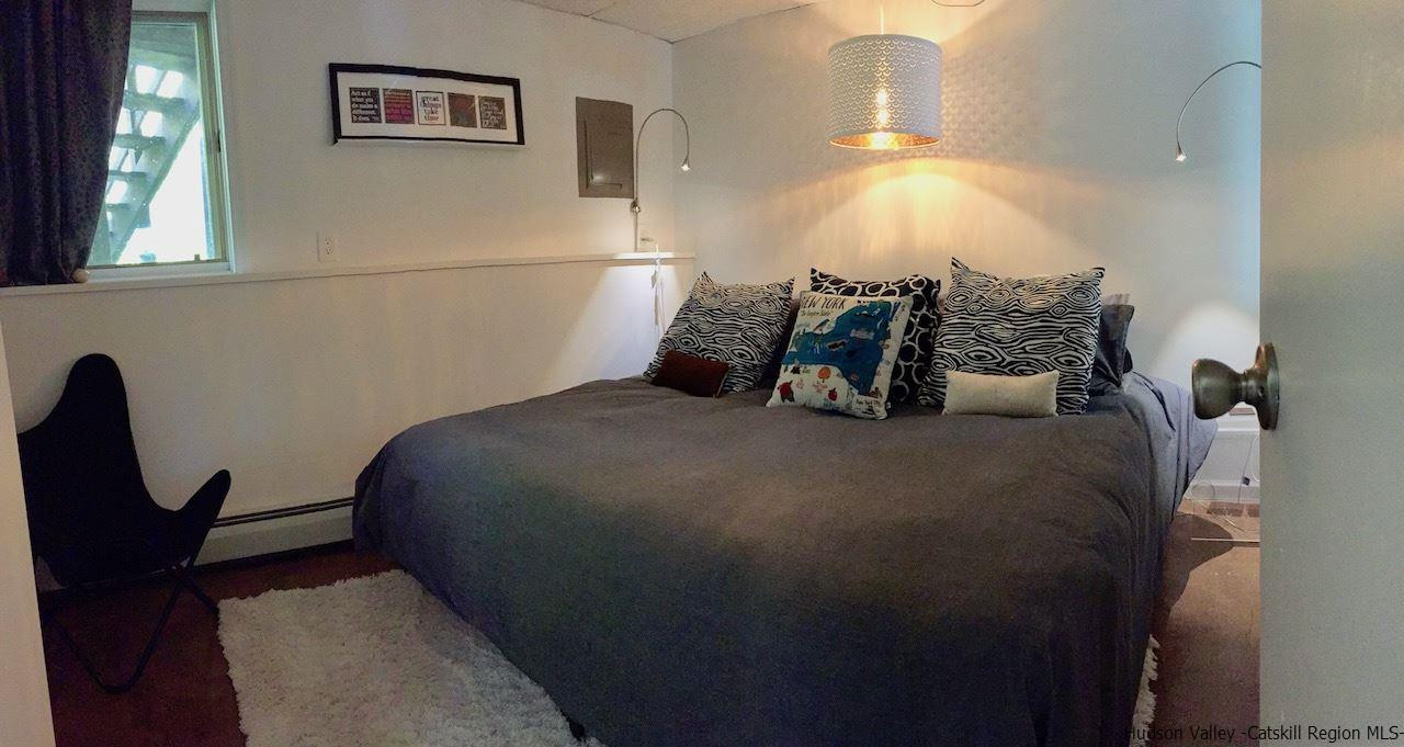 985 Cold Spring Road Roxbury, NY 12474 - Photo 28 of 35 a bedroom with a bed and a window