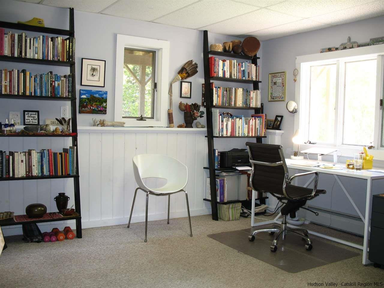 985 Cold Spring Road Roxbury, NY 12474 - Photo 6 of 35 a view of a workspace with a bookshelf and a workspace
