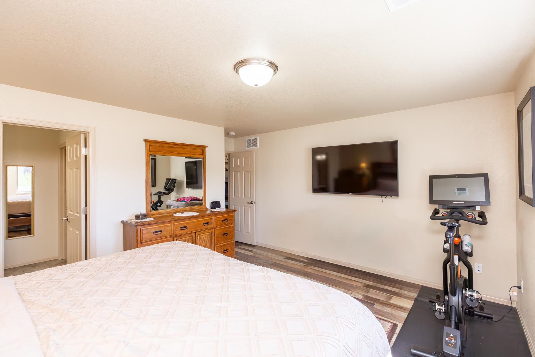 103 Red Rocks Street Fruita, CO 81521 - Photo 35 of 39 a bedroom with a bed and a flat screen tv
