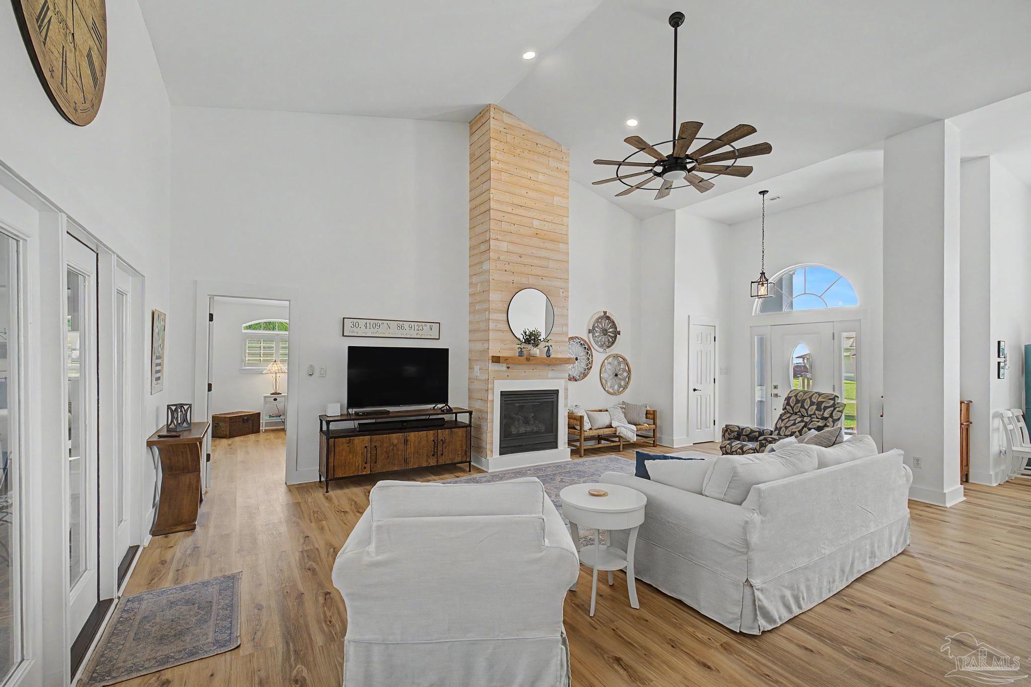 2005 Riviera Lane South Navarre, FL 32566 - Photo 39 of 70 a living room with furniture a fireplace and a flat screen tv