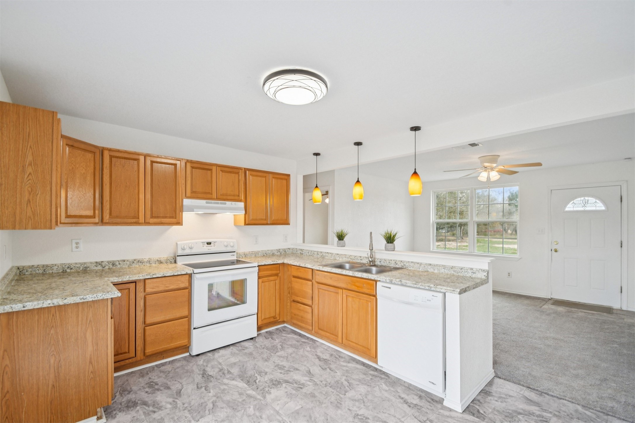 1470 Oak Grove Road Leander, TX 78641 - Photo 11 of 38 a kitchen that has a sink and a stove in it