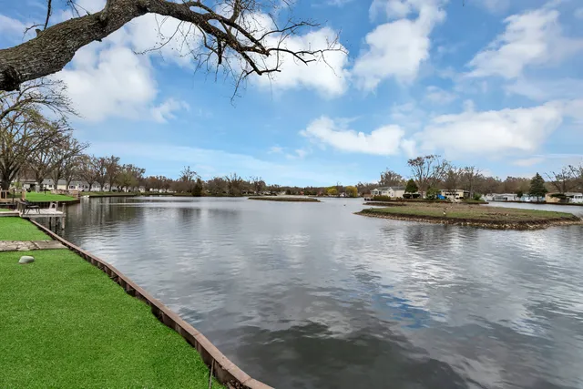 a view of a lake with houses in the back