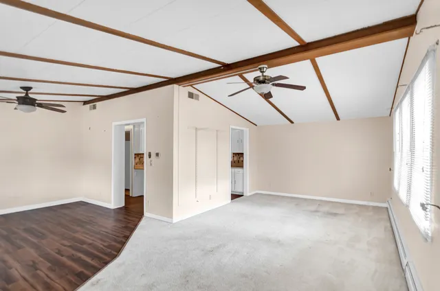 a view of hallway with wooden floor and stairs