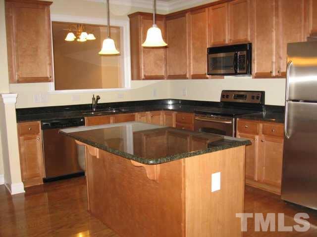 7761 Courtney Estates Drive Raleigh, NC 27617 - Photo 4 of 6 a kitchen with stainless steel appliances granite countertop a sink a stove and a microwave