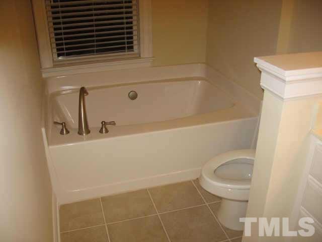 7761 Courtney Estates Drive Raleigh, NC 27617 - Photo 6 of 6 a bathroom with a sink a toilet and shower
