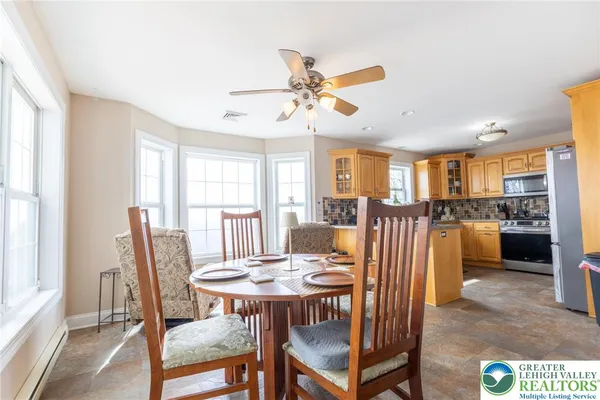 a dining room with furniture and window