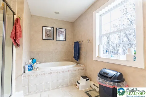 a bathroom with a tub sink and a window