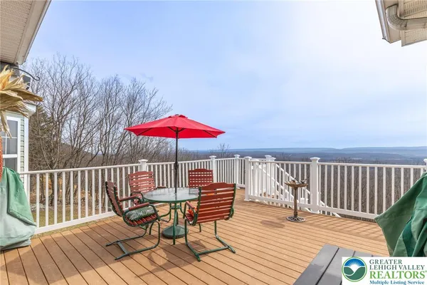 a view of balcony with wooden floor and outdoor seating
