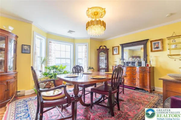 a dining room with a table and chairs
