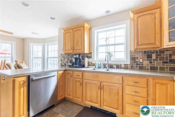 a kitchen with granite countertop white cabinets and sink