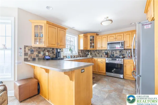 a kitchen with stainless steel appliances granite countertop a sink and a stove