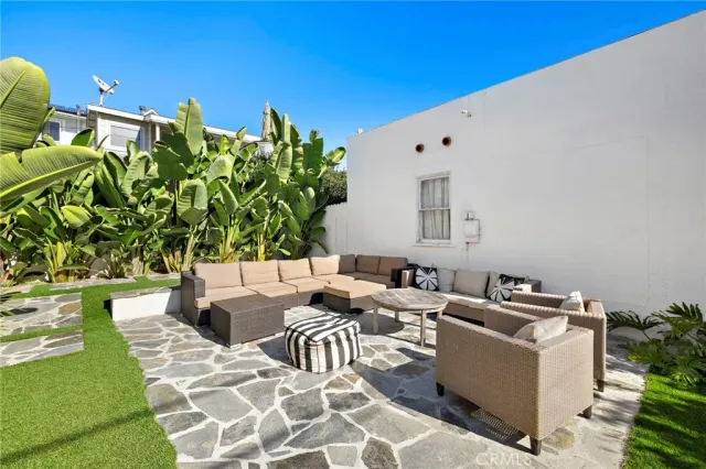 a view of a patio with couches and potted plants