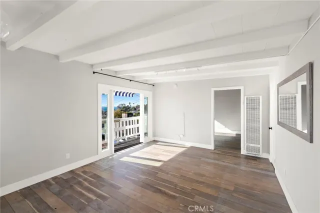 a view of an empty room with glass door