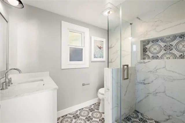 a bathroom with a sink toilet and shower