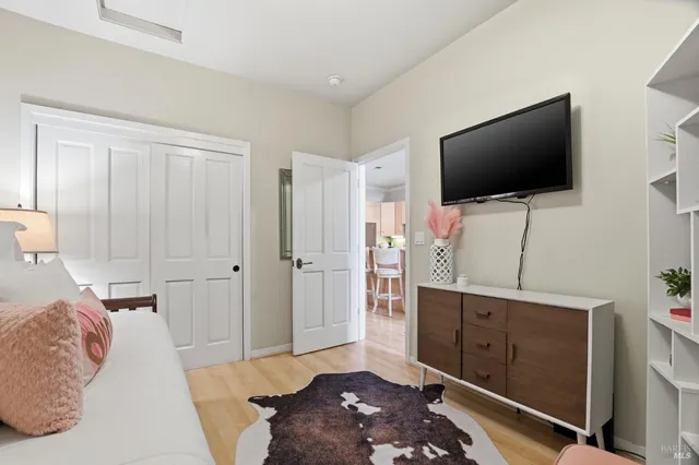 a bedroom with a bed and a flat screen tv