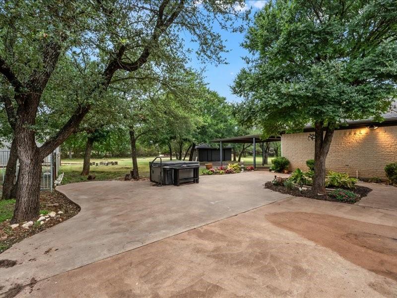 1072 Chapman Road Crawford, TX 76638 - Photo 28 of 39 a view of a patio with table and chairs potted plants and a large tree