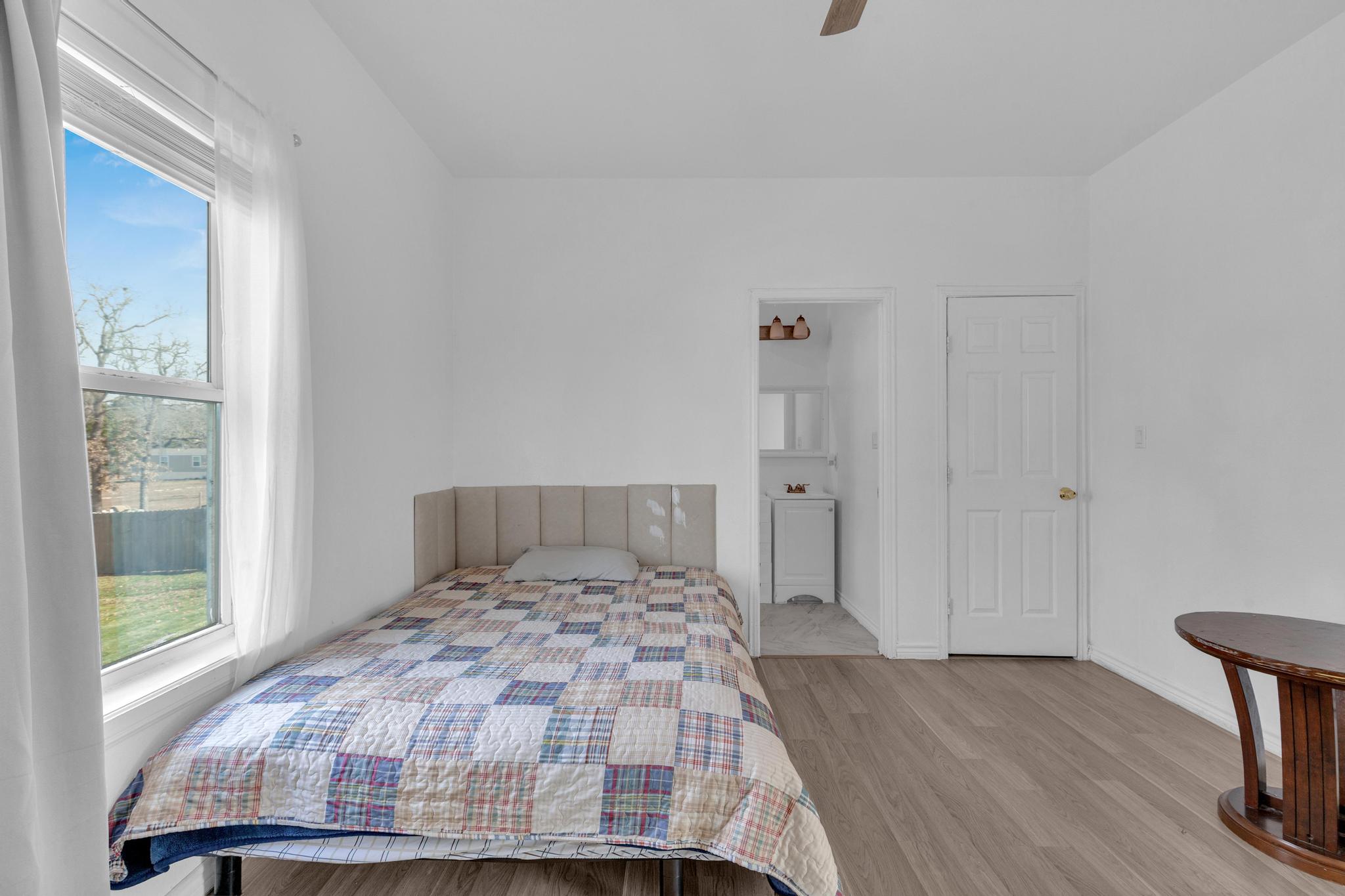 114 Crepe Myrtle Parkway Elgin, TX 78621 - Photo 21 of 40 Unit B - Bedroom with light wood-style flooring, ceiling fan, and ensuite bathroom