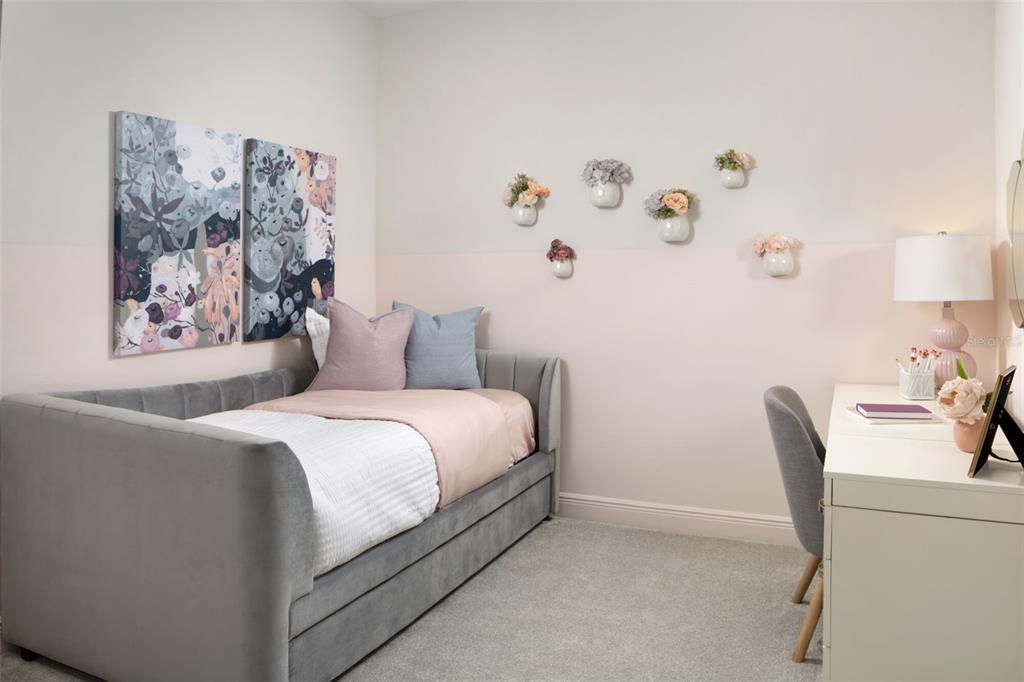 1859 Seawall Way Celebration, FL 34747 - Photo 12 of 25 a bedroom with a bed and a desk