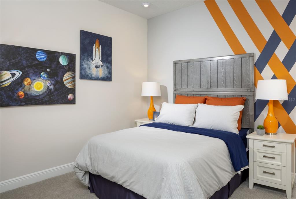 1859 Seawall Way Celebration, FL 34747 - Photo 13 of 25 a bedroom with a bed and lamp