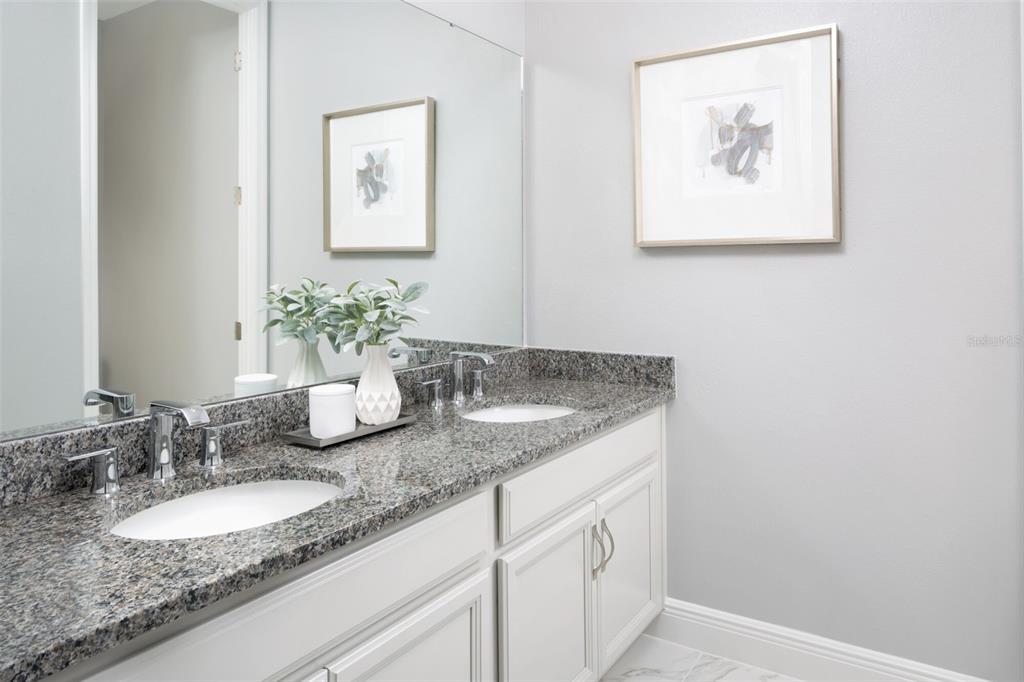 1859 Seawall Way Celebration, FL 34747 - Photo 14 of 25 a bathroom with a granite countertop sink and a mirror