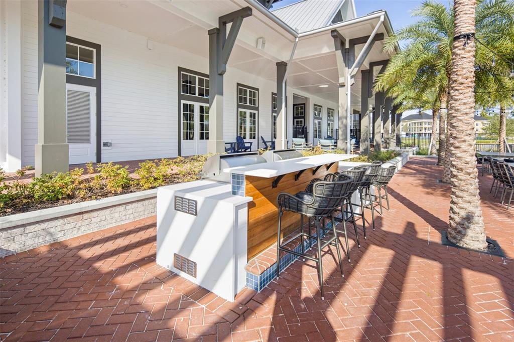 1859 Seawall Way Celebration, FL 34747 - Photo 17 of 25 a view of a patio with couches table and chairs and potted plants