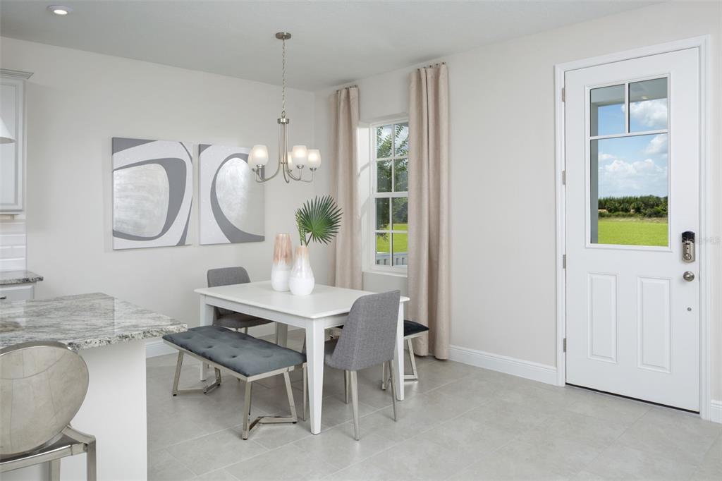 1859 Seawall Way Celebration, FL 34747 - Photo 7 of 25 a view of a dining room that has a table and chairs in it