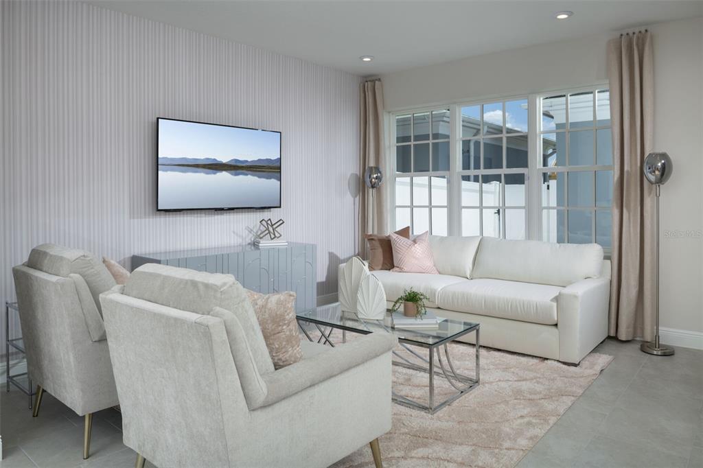 1859 Seawall Way Celebration, FL 34747 - Photo 8 of 25 a living room with furniture and a flat screen tv