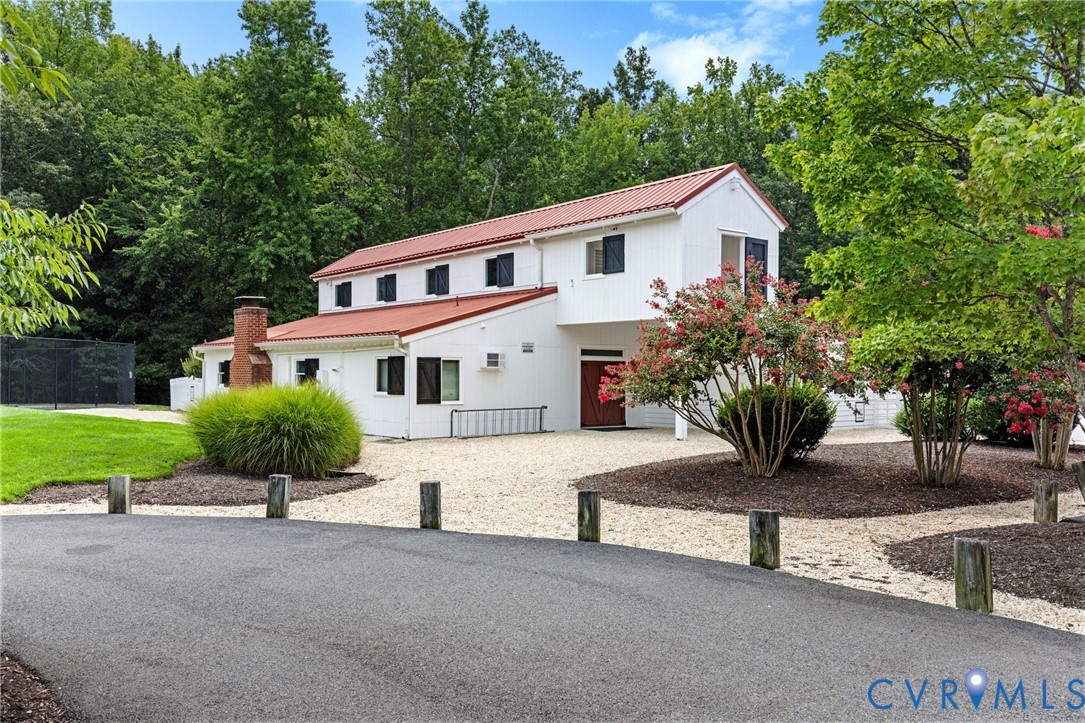 14019 Princess Mary Road Chesterfield, VA 23838 - Photo 59 of 61 White exterior with a red metal roof, black shutte