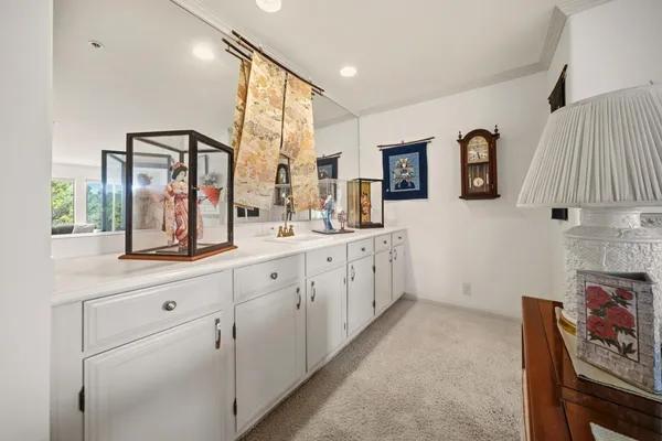 a bathroom with a double vanity sink mirror and shower