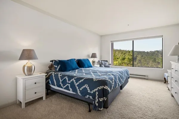 a bed sitting in a bedroom next to a window