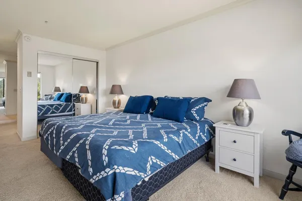 a bedroom with a bed and lamp with window