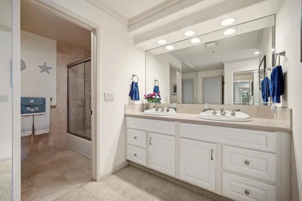a bathroom with a granite countertop sink mirror and shower