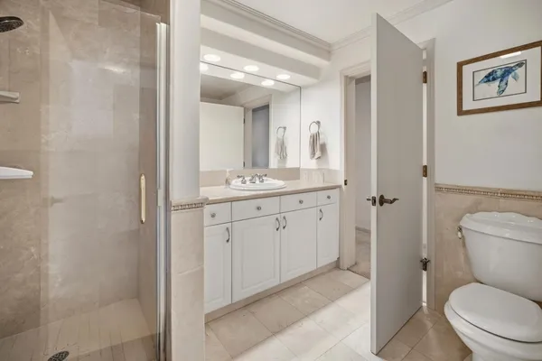 a spacious bathroom with a toilet sink and a mirror