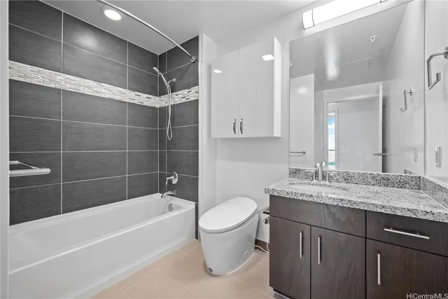 a bathroom with a granite countertop sink a toilet and bathtub