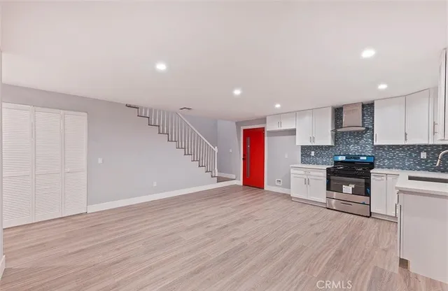 a view of kitchen with wooden floor and electronic appliances
