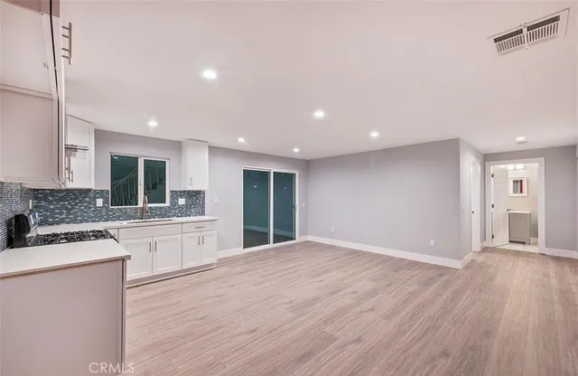 a large kitchen with kitchen island a sink stainless steel appliances and cabinets