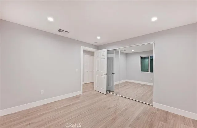 a view of hallway with wooden floor