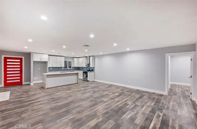 a view of kitchen with kitchen island microwave and stove