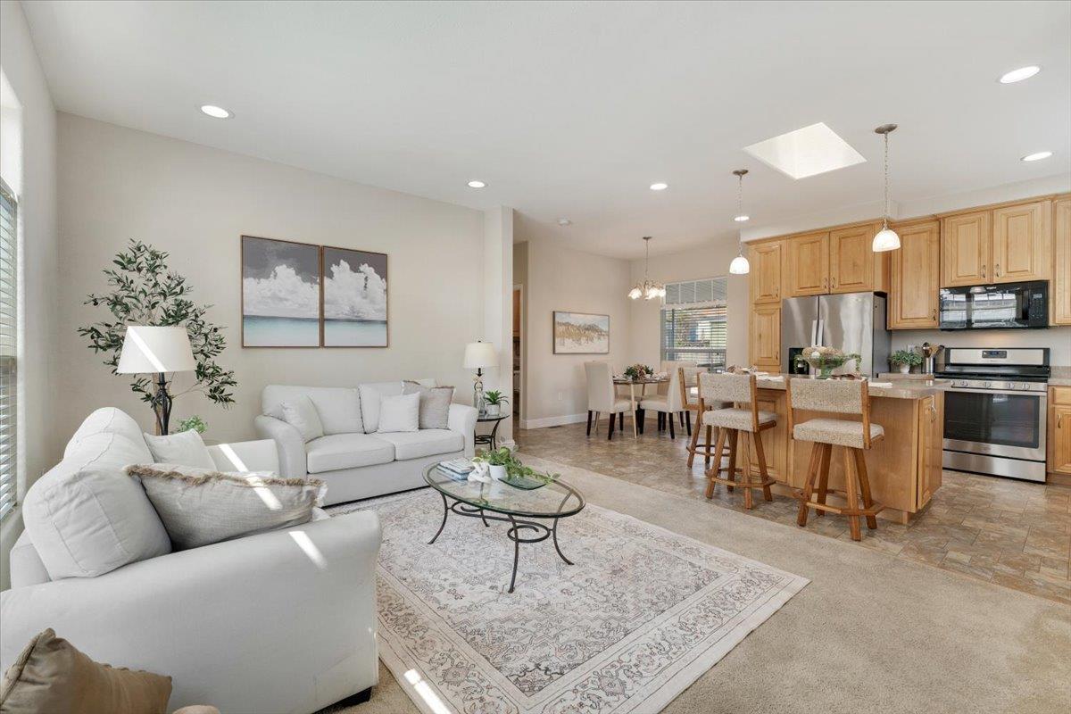 a living room with furniture kitchen view and a dining table
