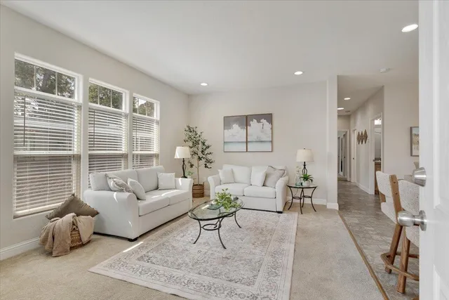 a living room with furniture and windows