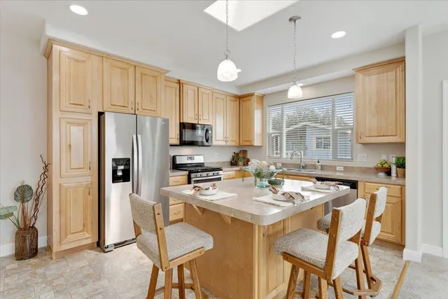a kitchen with stainless steel appliances granite countertop white cabinets sink and a granite counter tops