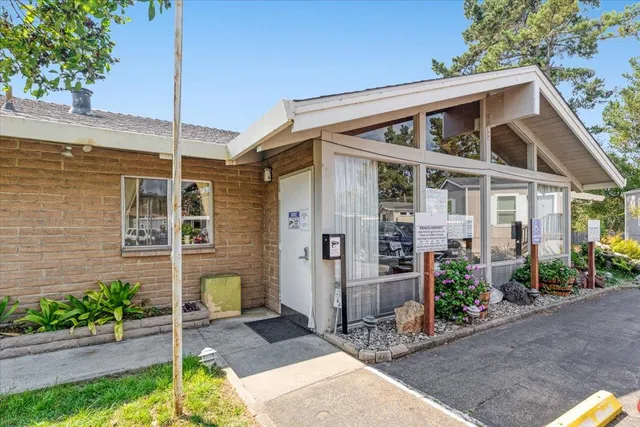 a room with pool table and windows