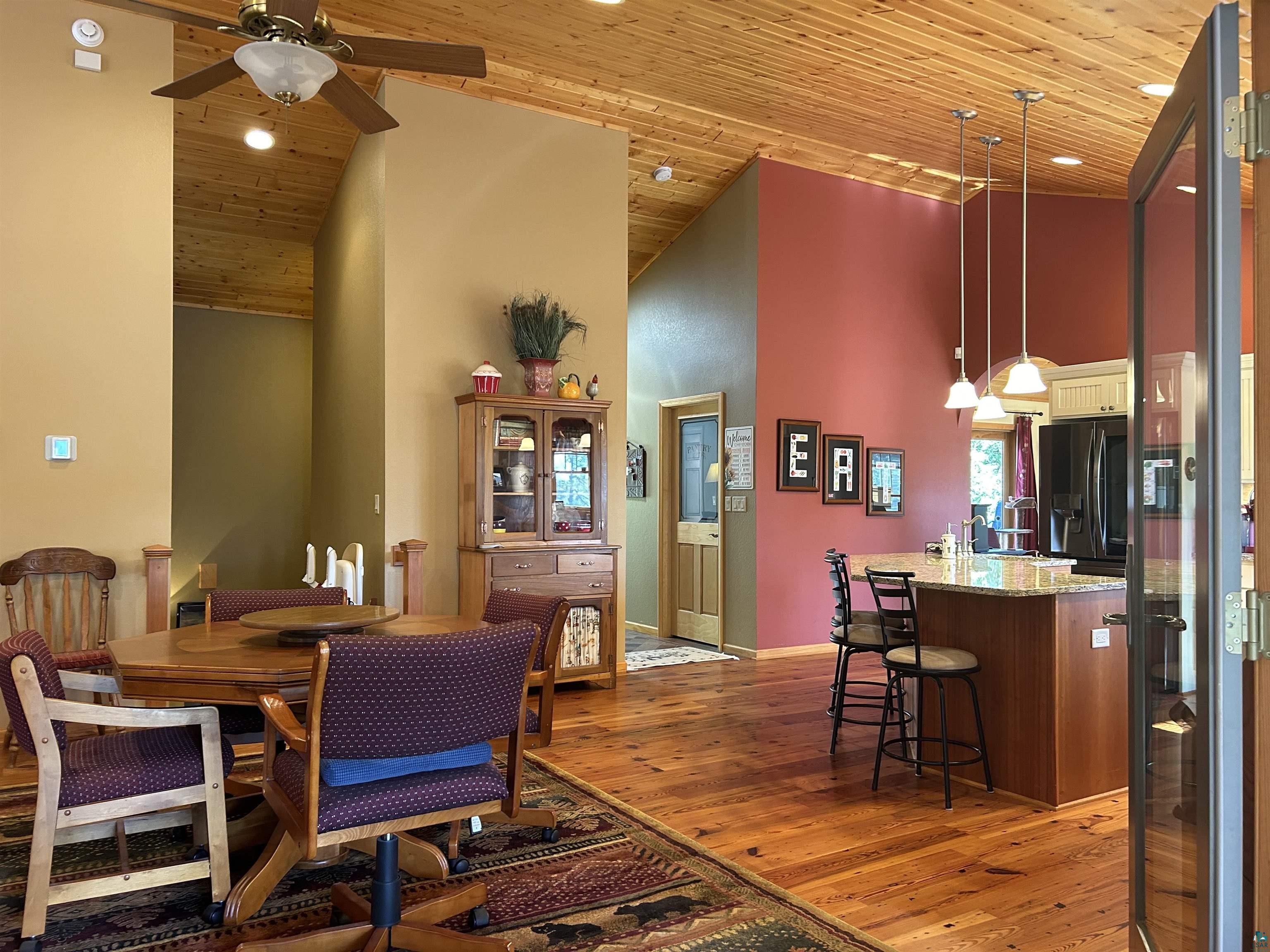 10115 Island Lake Road Solon Springs, WI 54873 - Photo 16 of 56 Dining area with ceiling fan, high vaulted ceiling, light wood-style floors, wooden ceiling, and baseboards