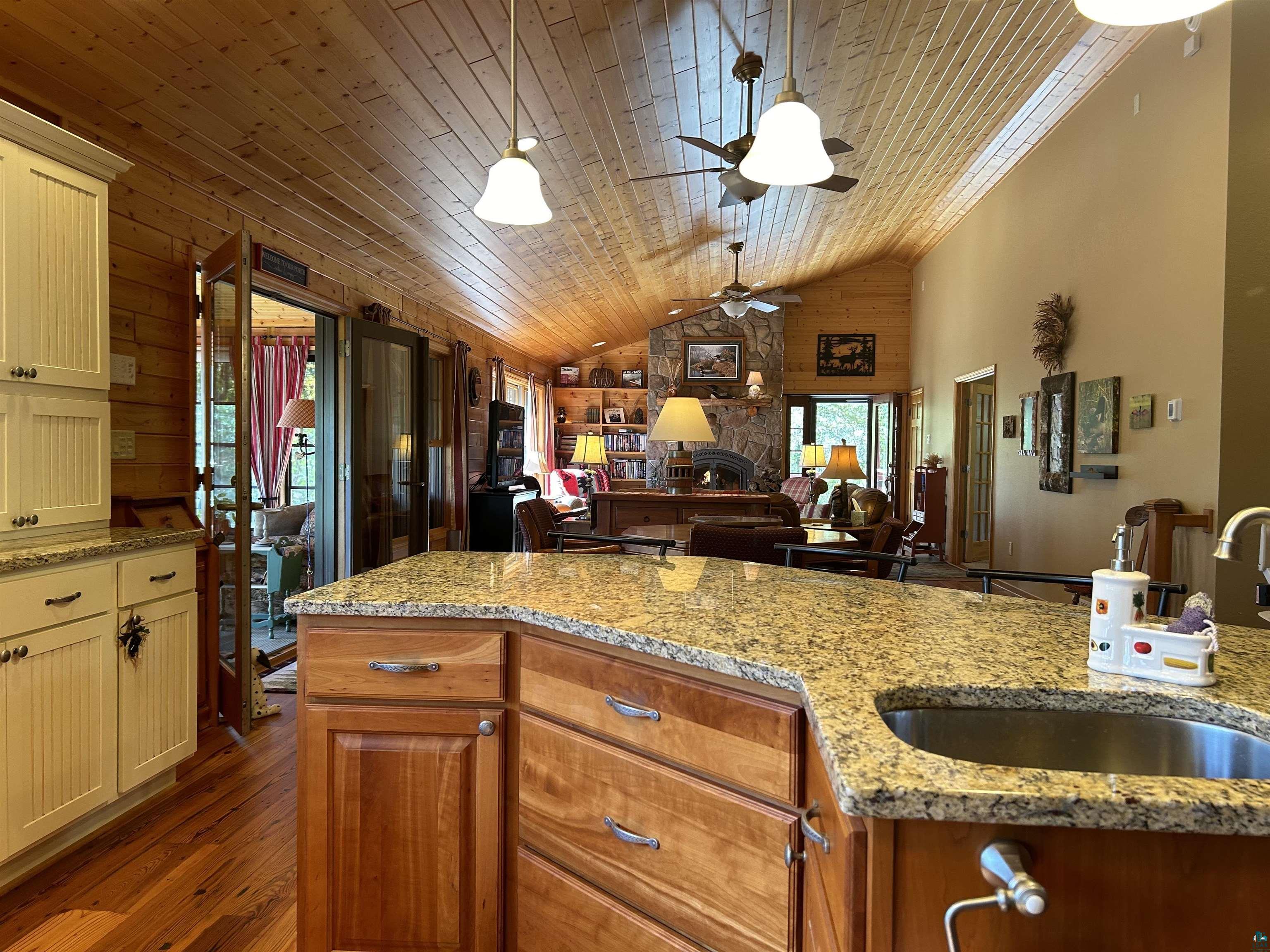 10115 Island Lake Road Solon Springs, WI 54873 - Photo 17 of 56 Kitchen with wooden ceiling, lofted ceiling, a sink, ceiling fan, and dark wood-style floors