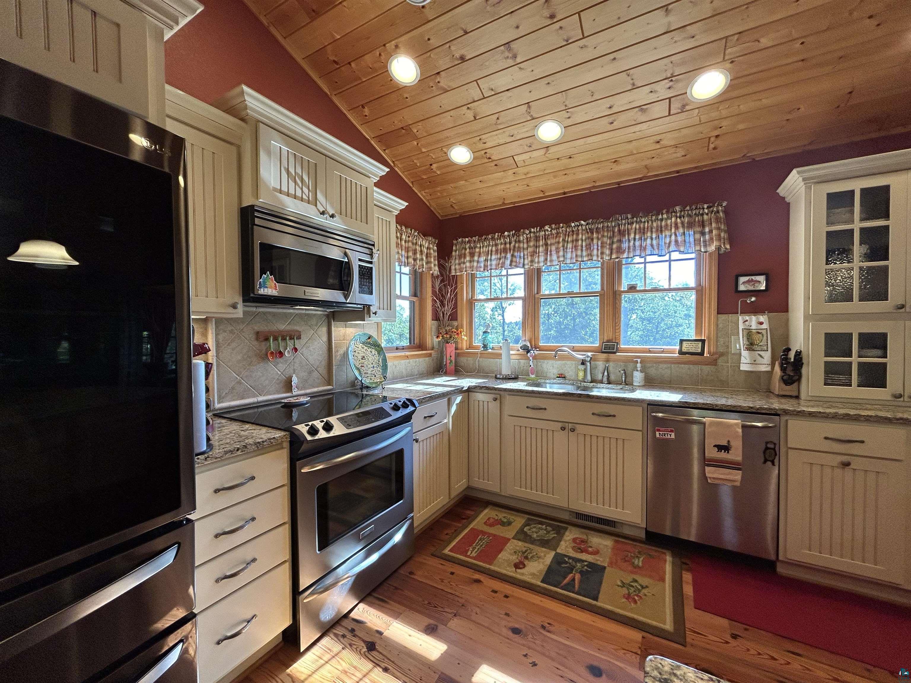 10115 Island Lake Road Solon Springs, WI 54873 - Photo 20 of 56 Kitchen with stainless steel appliances, recessed lighting, wood ceiling, vaulted ceiling, and a sink