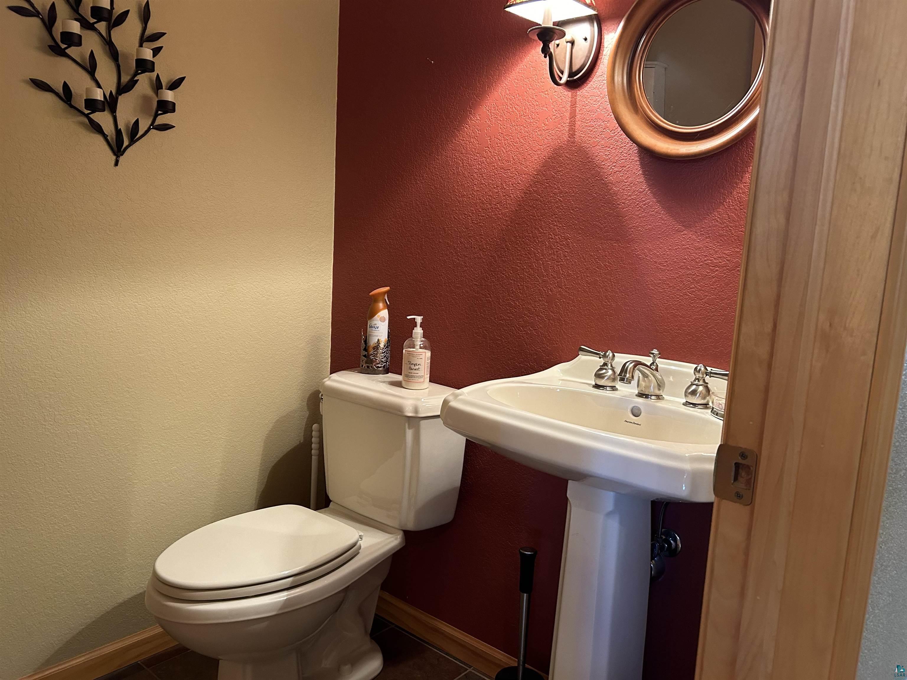10115 Island Lake Road Solon Springs, WI 54873 - Photo 27 of 56 Half bath featuring toilet, tile patterned floors, and baseboards