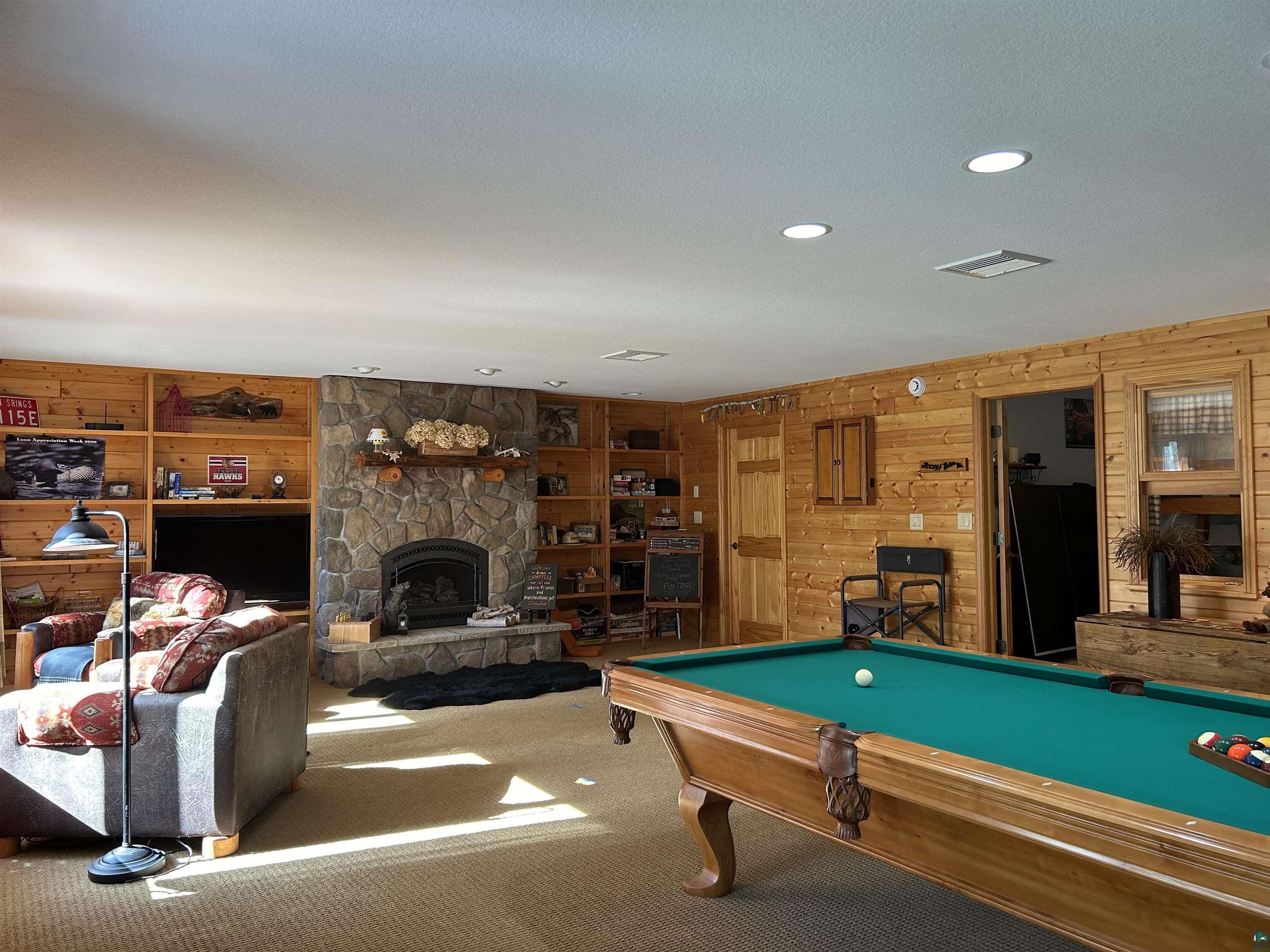 10115 Island Lake Road Solon Springs, WI 54873 - Photo 33 of 56 Playroom featuring wooden walls, carpet, a fireplace, pool table, and recessed lighting