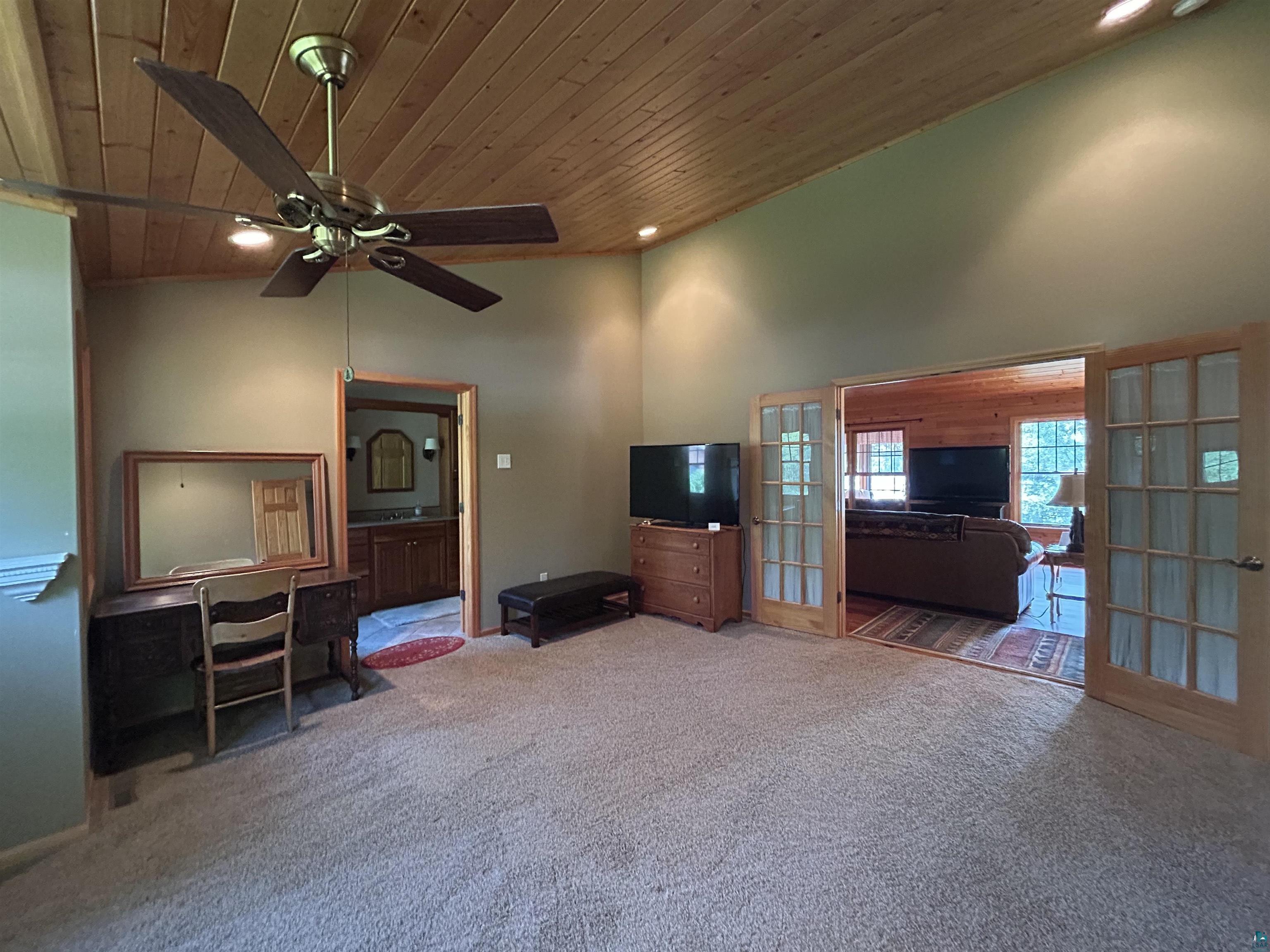 10115 Island Lake Road Solon Springs, WI 54873 - Photo 50 of 56 Living room with wooden ceiling, carpet flooring, a ceiling fan, french doors, and recessed lighting